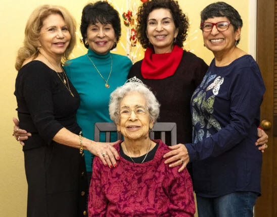 Mildred Hernandez, seated, with her daughters. Courtesy of Dudensing Law